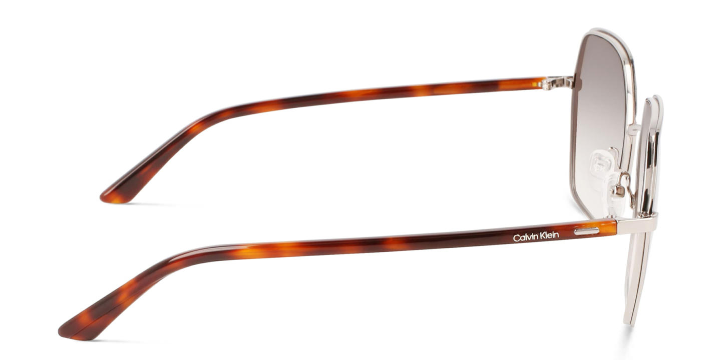 Shop Calvin Klein Irregular Sunglasses in Brown online.