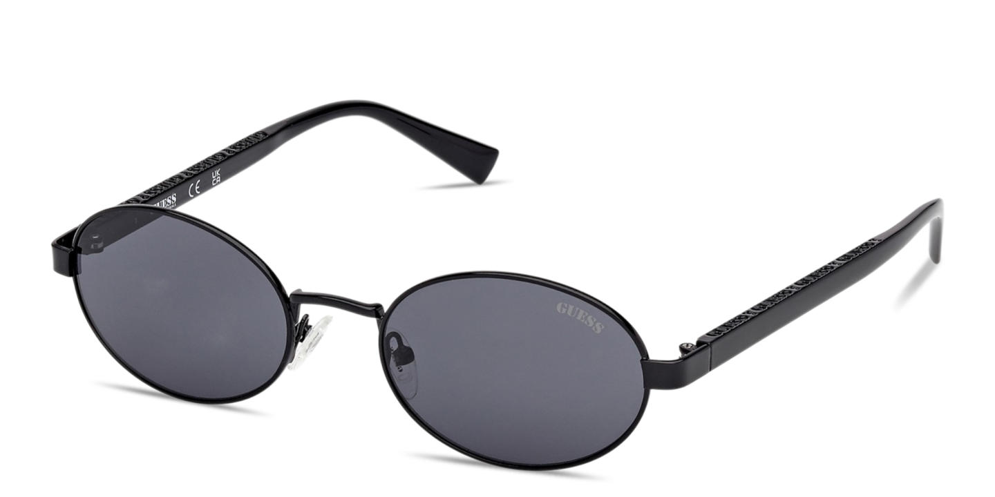 Shop Guess Engraved Logo Unisex Oval Sunglasses in Black online.