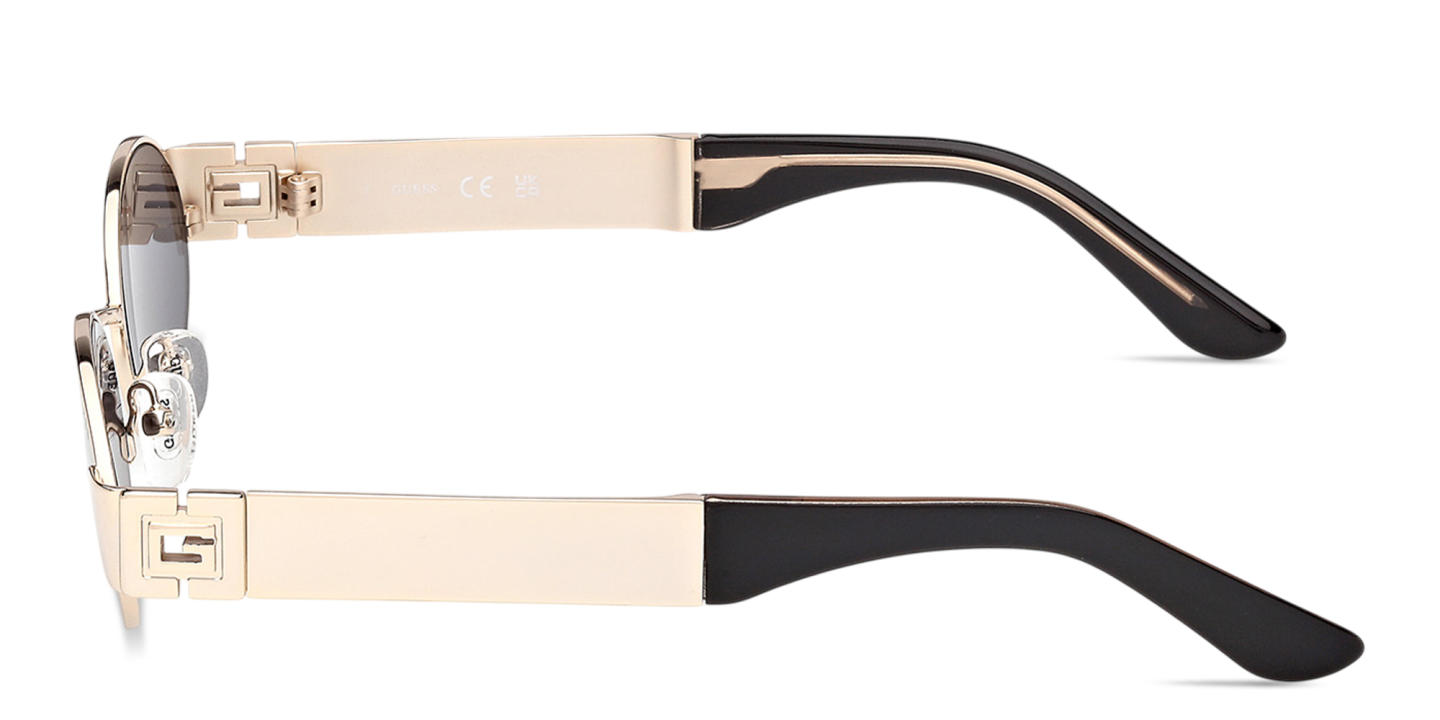 Shop Guess Iris Oval Sunglasses in Gold online.